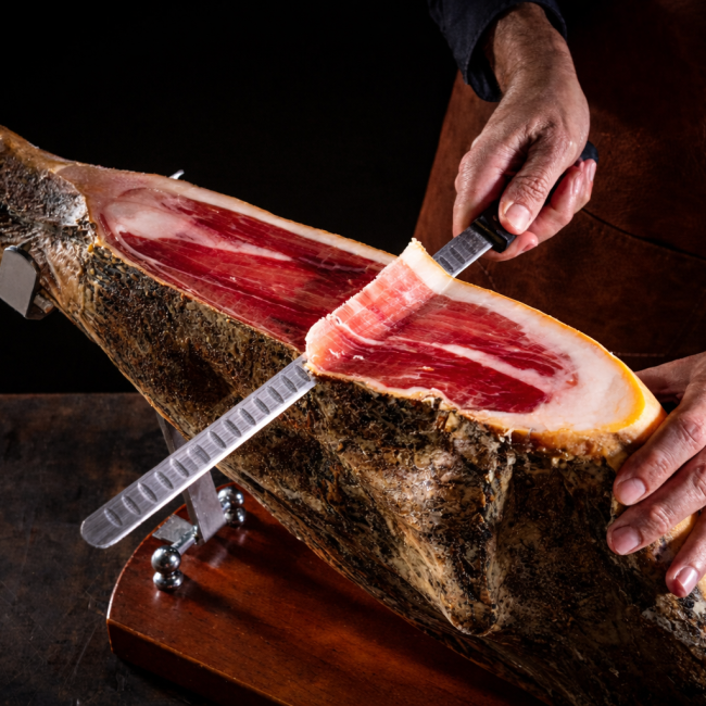 cured ham being sliced